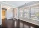 Bright room with hardwood floors featuring large windows for natural light and crown molding at 4905 Sterling Close, Buford, GA 30518
