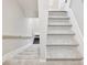 Carpeted stairway leading to the upper level, showcasing modern design and neutral tones at 4905 Sterling Close, Buford, GA 30518