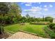 Well maintained backyard with lush grass, stone path, and stone picnic table and benches at 505 Ansley Villa Dr, Atlanta, GA 30324
