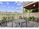 Back patio with metal table and chairs, surrounded by white fence and under the deck above at 505 Ansley Villa Dr, Atlanta, GA 30324