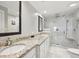 Bathroom with double sinks, granite countertops, and a glass shower at 505 Ansley Villa Dr, Atlanta, GA 30324