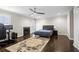 Spacious bedroom with a fireplace, hardwood floors, and a ceiling fan at 505 Ansley Villa Dr, Atlanta, GA 30324