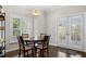 Cozy dining area with hardwood floors, modern lighting, and views to the outside patio at 505 Ansley Villa Dr, Atlanta, GA 30324