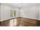 Bright dining room with hardwood floors, modern chandelier, and large window at 505 Ansley Villa Dr, Atlanta, GA 30324