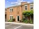 Townhome exterior featuring brick facade, manicured landscaping, brick walkway and black railings at 505 Ansley Villa Dr, Atlanta, GA 30324