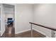 Hallway with hardwood floors leading to a bedroom with a fireplace at 505 Ansley Villa Dr, Atlanta, GA 30324