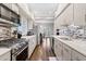 Galley kitchen with stainless steel appliances, a mosaic backsplash, and hardwood floors at 505 Ansley Villa Dr, Atlanta, GA 30324