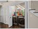Convenient laundry room features a side-by-side washer and dryer setup and built-in shelving at 505 Ansley Villa Dr, Atlanta, GA 30324
