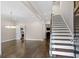 Spacious living room featuring hardwood floors, stairs to upper level and neutral color palette at 505 Ansley Villa Dr, Atlanta, GA 30324