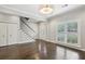 Open living area with sleek staircase, hardwood floors, and natural light at 505 Ansley Villa Dr, Atlanta, GA 30324