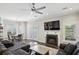 Cozy living room with fireplace, hardwood floors, ceiling fan, and plantation shutters at 505 Ansley Villa Dr, Atlanta, GA 30324