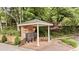 A lovely, brick-paved community mailbox area, complete with a shelter, bench, and professionally maintained landscaping at 505 Ansley Villa Dr, Atlanta, GA 30324