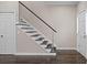 Staircase with hardwood floors and modern steel cable railing at 505 Ansley Villa Dr, Atlanta, GA 30324