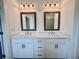 Bathroom featuring double vanity with framed mirrors and modern fixtures at 508 Healy Dr # 70, Cumming, GA 30040