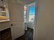 Half bathroom features a pedestal sink, lighting, and a window with neighborhood views at 508 Healy Dr # 70, Cumming, GA 30040