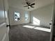 Bedroom with carpet, large windows, and a ceiling fan for comfort and natural light at 508 Healy Dr # 70, Cumming, GA 30040