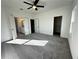 Spacious carpeted bedroom with ceiling fan and view to bathroom and closet at 508 Healy Dr # 70, Cumming, GA 30040