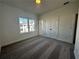 Carpeted bedroom featuring window views and double door closet at 508 Healy Dr # 70, Cumming, GA 30040