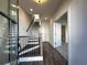 Bright entryway features wood-look flooring, staircase with black railings, and access to a bathroom at 508 Healy Dr # 70, Cumming, GA 30040