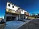 Low-angle view shows townhomes each with an upper-level porch and ground-level garages at 508 Healy Dr # 70, Cumming, GA 30040