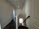 Hallway features hardwood floors leading to other rooms; staircase on the right at 508 Healy Dr # 70, Cumming, GA 30040