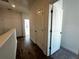 Upstairs hallway with hardwood flooring, white trim and doors at 508 Healy Dr # 70, Cumming, GA 30040