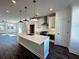 Stylish kitchen with large island, stainless steel appliances, and modern pendant lighting at 508 Healy Dr # 70, Cumming, GA 30040