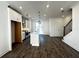 Open-concept kitchen boasts a center island, stainless steel appliances, and adjacent living space at 508 Healy Dr # 70, Cumming, GA 30040