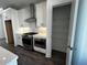 Modern kitchen includes stainless appliances, white cabinets, pantry with shelves, and tiled backsplash at 508 Healy Dr # 70, Cumming, GA 30040