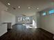 Bright living room features beautiful hardwood floors, recessed lighting, and large windows at 508 Healy Dr # 70, Cumming, GA 30040