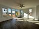 Bright living room features beautiful hardwood floors, a ceiling fan, and large windows at 508 Healy Dr # 70, Cumming, GA 30040
