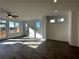 Bright living room features beautiful hardwood floors, a ceiling fan, and large windows at 508 Healy Dr # 70, Cumming, GA 30040