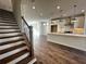 Open living space showing staircase and kitchen, featuring modern design and lighting at 508 Healy Dr # 70, Cumming, GA 30040