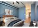 Comfortable bedroom with a modern ceiling fan, stylish decor, and a doorway to the laundry room at 115 W Peachtree Nw Pl # 713, Atlanta, GA 30313