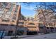 Beautiful brick apartment building features a street view with a garage and blue sky background at 115 W Peachtree Nw Pl # 713, Atlanta, GA 30313