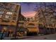 Beautiful brick apartment building features a street view with a garage and sunset background at 115 W Peachtree Nw Pl # 713, Atlanta, GA 30313