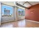 Bright living room with hardwood floors, large windows, and a view of the city skyline at 115 W Peachtree Nw Pl # 713, Atlanta, GA 30313