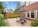 Private backyard patio featuring a stone surface, outdoor seating, and landscaped surroundings at 11945 Dancliff Trce, Alpharetta, GA 30009