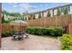Charming backyard patio with an iron table set, lush greenery, and privacy fence at 11945 Dancliff Trce, Alpharetta, GA 30009