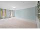 Spacious bedroom with soft blue walls, neutral carpet, and built-in shelving at 11945 Dancliff Trce, Alpharetta, GA 30009