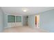 Open bedroom with light blue walls, built-in shelving, and access to a bathroom at 11945 Dancliff Trce, Alpharetta, GA 30009