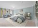 Beautiful bedroom with tufted headboard, soft blue walls, and decorative curtains at 11945 Dancliff Trce, Alpharetta, GA 30009