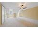 Spacious bedroom featuring a ceiling fan, angled ceilings, and plentiful natural light at 11945 Dancliff Trce, Alpharetta, GA 30009