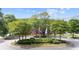 Aerial view of community clubhouse surrounded by a circular driveway and landscaping at 11945 Dancliff Trce, Alpharetta, GA 30009