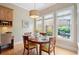 Cozy dining area with natural light, hardwood floors, and views of the private backyard at 11945 Dancliff Trce, Alpharetta, GA 30009