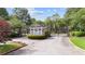 Community entrance with brick gatehouse, manicured landscaping, and gated entry at 11945 Dancliff Trce, Alpharetta, GA 30009