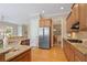 The Kitchen features wooden cabinets, stainless steel appliances, and granite countertops at 11945 Dancliff Trce, Alpharetta, GA 30009