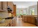 Well-lit kitchen featuring custom cabinets, granite countertops, stainless steel appliances, and a breakfast area at 11945 Dancliff Trce, Alpharetta, GA 30009
