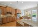 Bright kitchen with granite countertops, stainless steel appliances, and a view to the breakfast area at 11945 Dancliff Trce, Alpharetta, GA 30009