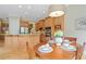 Eat-in kitchen area with wooden table set for four, and a large window with a view of the main kitchen area at 11945 Dancliff Trce, Alpharetta, GA 30009